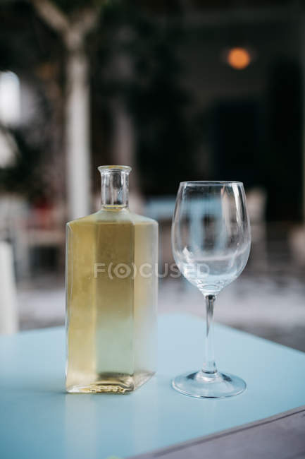Cropped image of white wine and glass, selective focus — Stock Photo