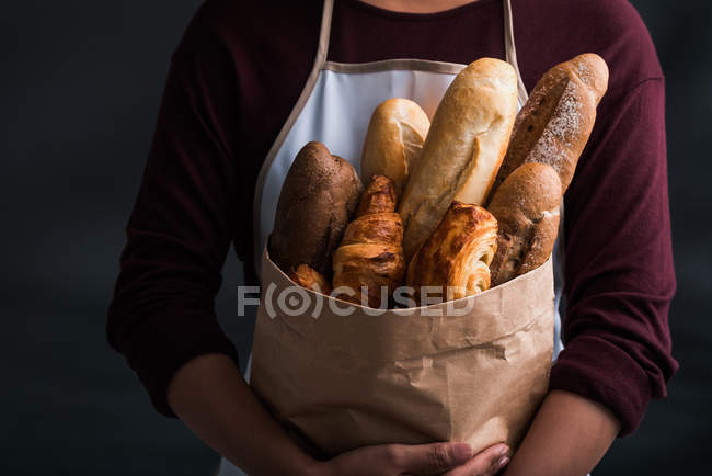 Frau mit Paket mit frischem Brot — Stockfoto