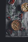 Vanilla pies with cherries and strawberries on wooden table — Stock Photo