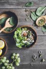 Salad bowl with shrimps, broccoli and green grapes on wooden surface — Stock Photo