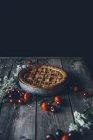 Homemade vanilla pie with cherries and strawberries on rustic wooden table — Stock Photo