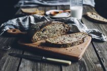 Freshly baked homemade bread on wooden board — Stock Photo
