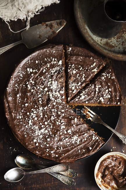 Partly sliced homemade chocolate cake — Stock Photo