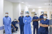 Team of doctors and nurses in hospital corridor — Stock Photo