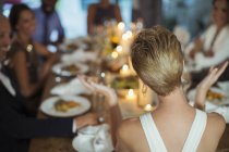 Woman clapping at dinner party — Stock Photo