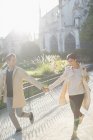 Couple holding hands in urban park — Stock Photo