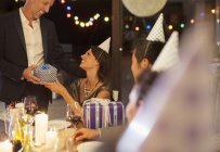Man giving present at birthday party — Stock Photo