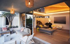 Illuminated living room open to patio — Stock Photo