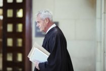 Judge walking through courthouse — Stock Photo