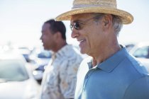 Senior men in sunny parking lot — Stock Photo