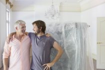 Father and son hugging in living space — Stock Photo