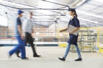 Workers walking in food processing plant — Stock Photo