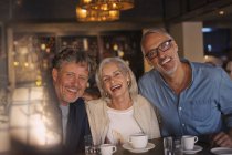 Portrait laughing friends drinking coffee in restaurant — Stock Photo