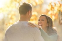 Laughing mature couple face to face outdoors — Stock Photo