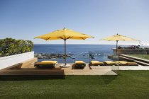 Liegestühle mit Blick auf Infinity Pool und Meer — Stockfoto