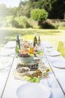 Teller mit Essen auf dem Tisch im Freien — Stockfoto