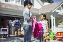 Mother and daughter shopping for clothes at yard sale — Stock Photo