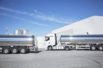 Stainless steel milk tankers parked — Stock Photo