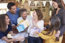 Older woman being given gift by family — Stock Photo