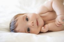 Adorable baby girl laying on bed — Stock Photo