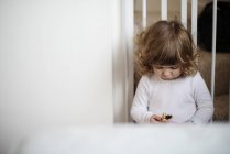 Girl eating snack on stairs — Stock Photo