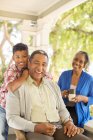 Portrait of smiling grandparents and grandson on porch — Stock Photo