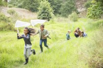 Children playing with butterfly nets on dirt path — Stock Photo
