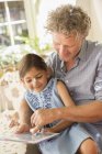 Grandfather and granddaughter using digital tablet together — Stock Photo