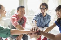 Creative business people connecting hands in huddle — Stock Photo