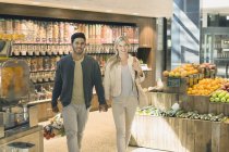 Retrato jovem casal de mãos dadas, compras de supermercado no mercado — Fotografia de Stock