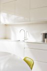 Simple faucet in modern white kitchen — Stock Photo