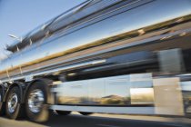 Blurred view of stainless steel milk tanker on the move — Stock Photo