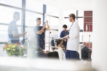 Doctors taking care of patients undergoing medical treatment in outpatient clinic — Stock Photo