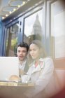 Business people using laptop at sidewalk cafe — Stock Photo
