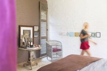 Blurred view of woman walking in bedroom — Stock Photo
