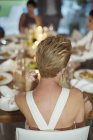 Woman sitting at dinner party — Stock Photo