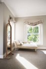 Chaise in sunny luxury bedroom — Stock Photo