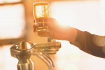 Bartender serving golden pint of beer at beer tap — Stock Photo