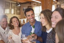 Happy modern family celebrating with drinks — Stock Photo