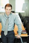 Businessman sitting at edge of conference table — Stock Photo
