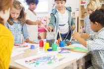 Students painting in classroom indoors — Stock Photo
