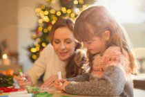 Mother and daughter making Christmas decorations — Stock Photo