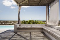 Luxo pátio junto à piscina com vista para o oceano — Fotografia de Stock
