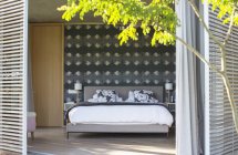 Patio shutters open to luxury bedroom — Stock Photo