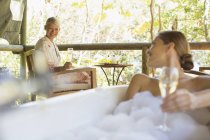 Women drinking wine together in spa — Stock Photo