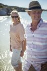 Couple walking in water together — Stock Photo