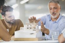 Architects discussing model in meeting — Stock Photo