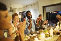 Friends cheering at dinner party — Stock Photo