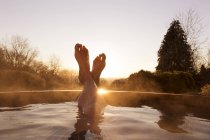 Man feet raised out of pool — Stock Photo