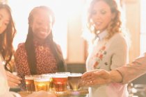 Women friends sampling beer at microbrewery bar — Stock Photo